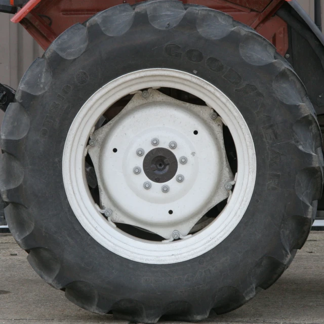 a large tire attached to a trailer on cement