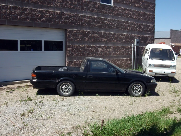a black pick up truck parked in front of a building