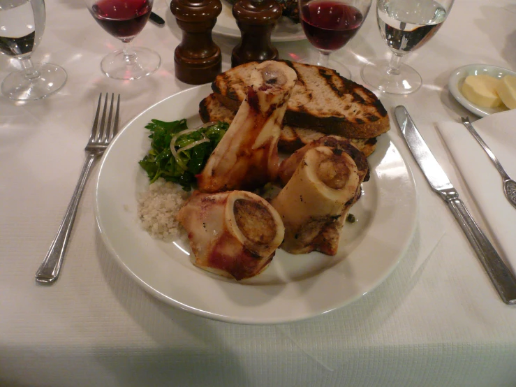 a white plate topped with meat and veggies