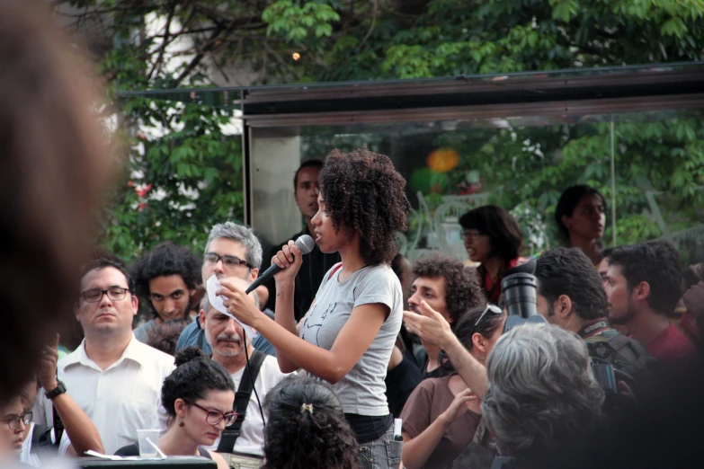 a woman giving a speech in front of an audience