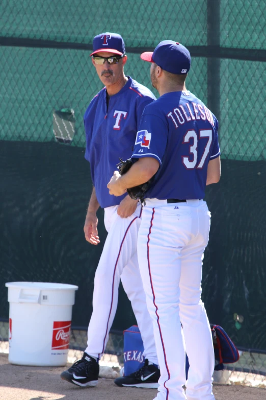 two baseball players in blue and white outfits