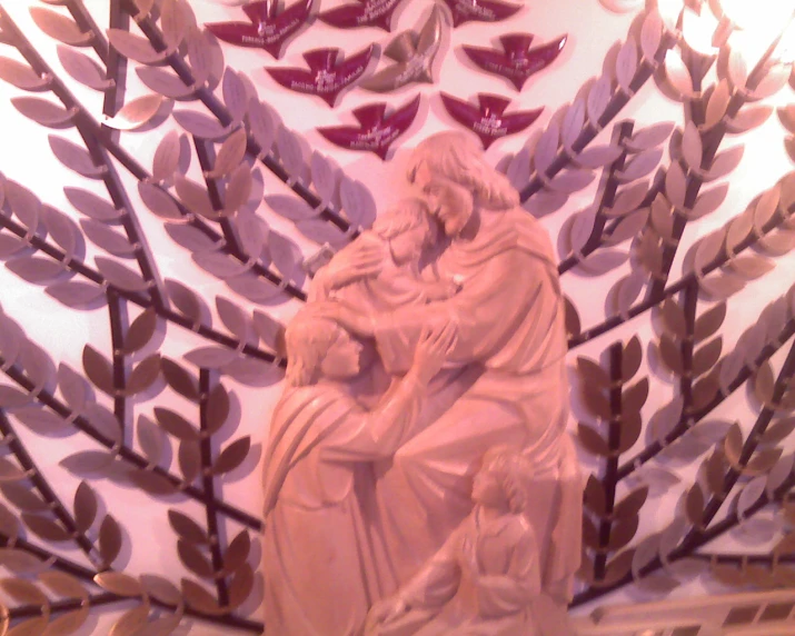 a sculpture of jesus and a child in a tree frame