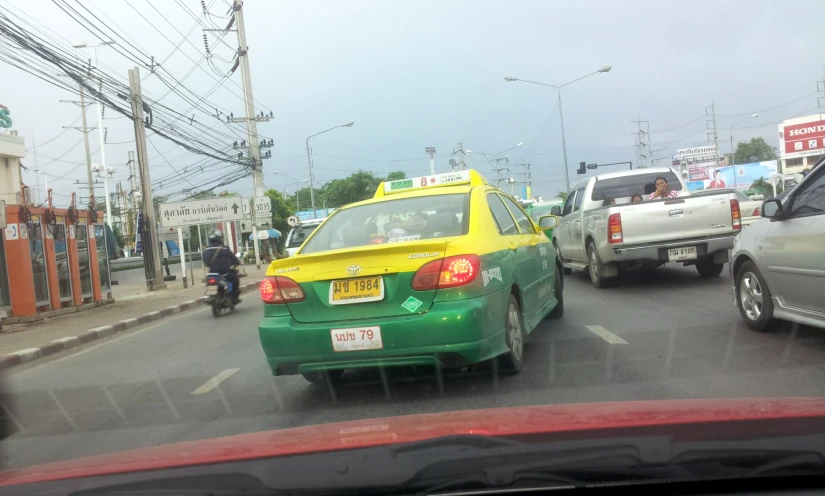 the yellow taxi has been stopped on the busy road