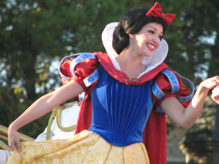 a woman is smiling while wearing a snow white outfit