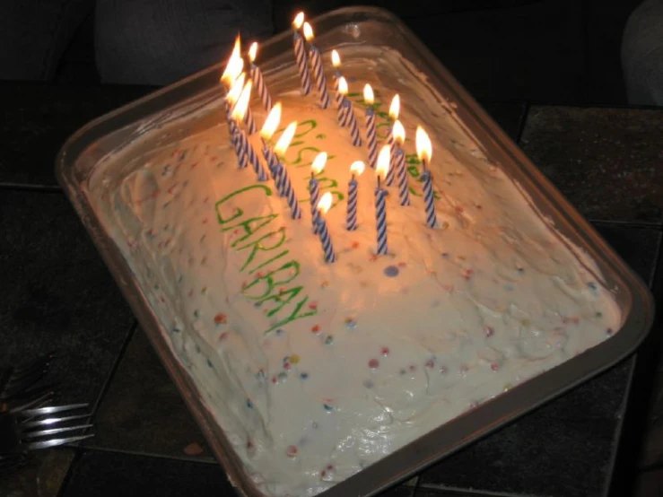 a birthday cake with lit candles and the number six on it