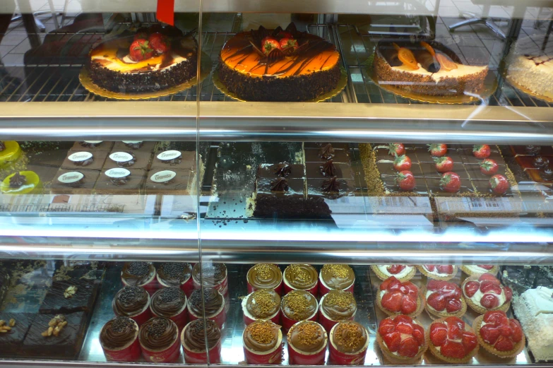 a display case filled with cakes and desserts