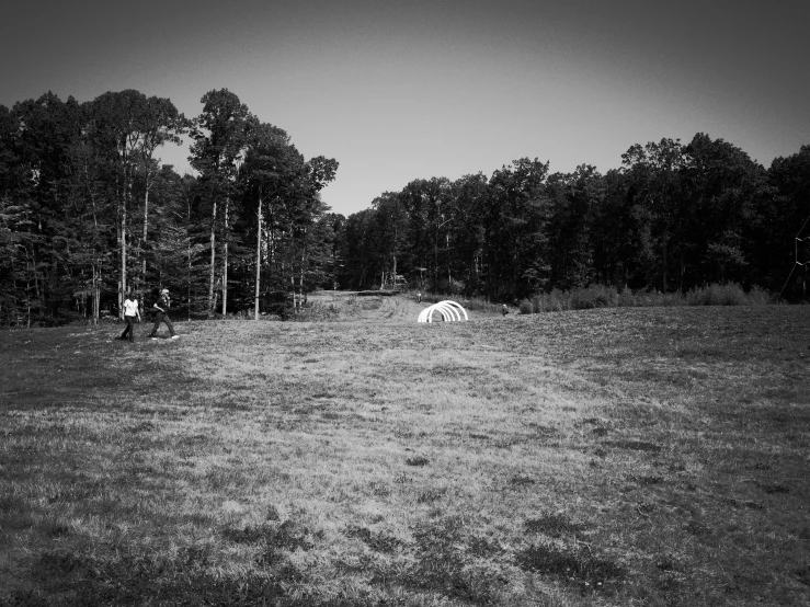 a black and white po of some people in the grass