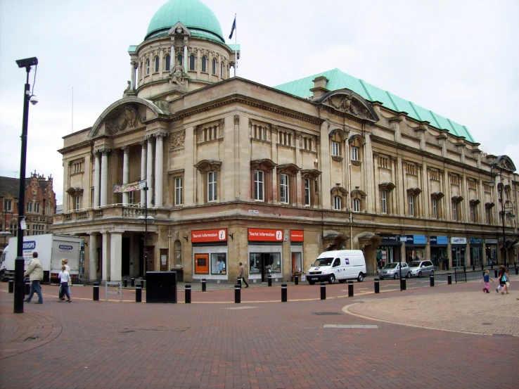 the corner of an old, historic building with a green dome on top