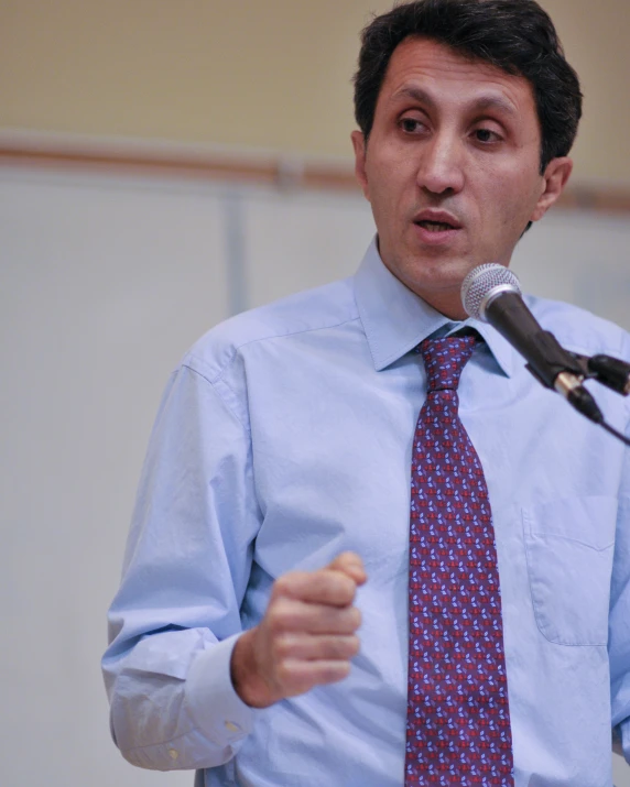 a man talking into a microphone at a conference