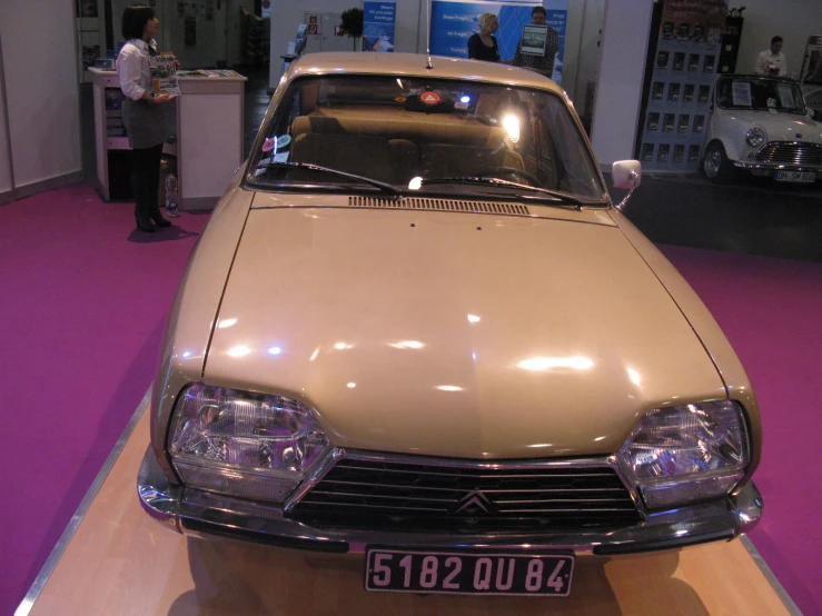 an old model car on display at a car show