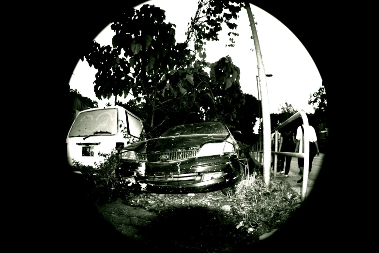 a car sits abandoned next to two rvs