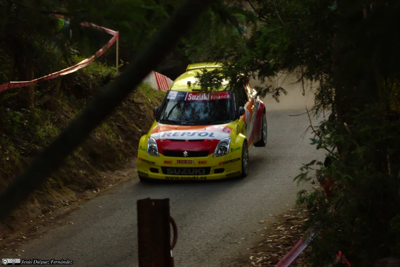 a yellow vehicle is driving down a road