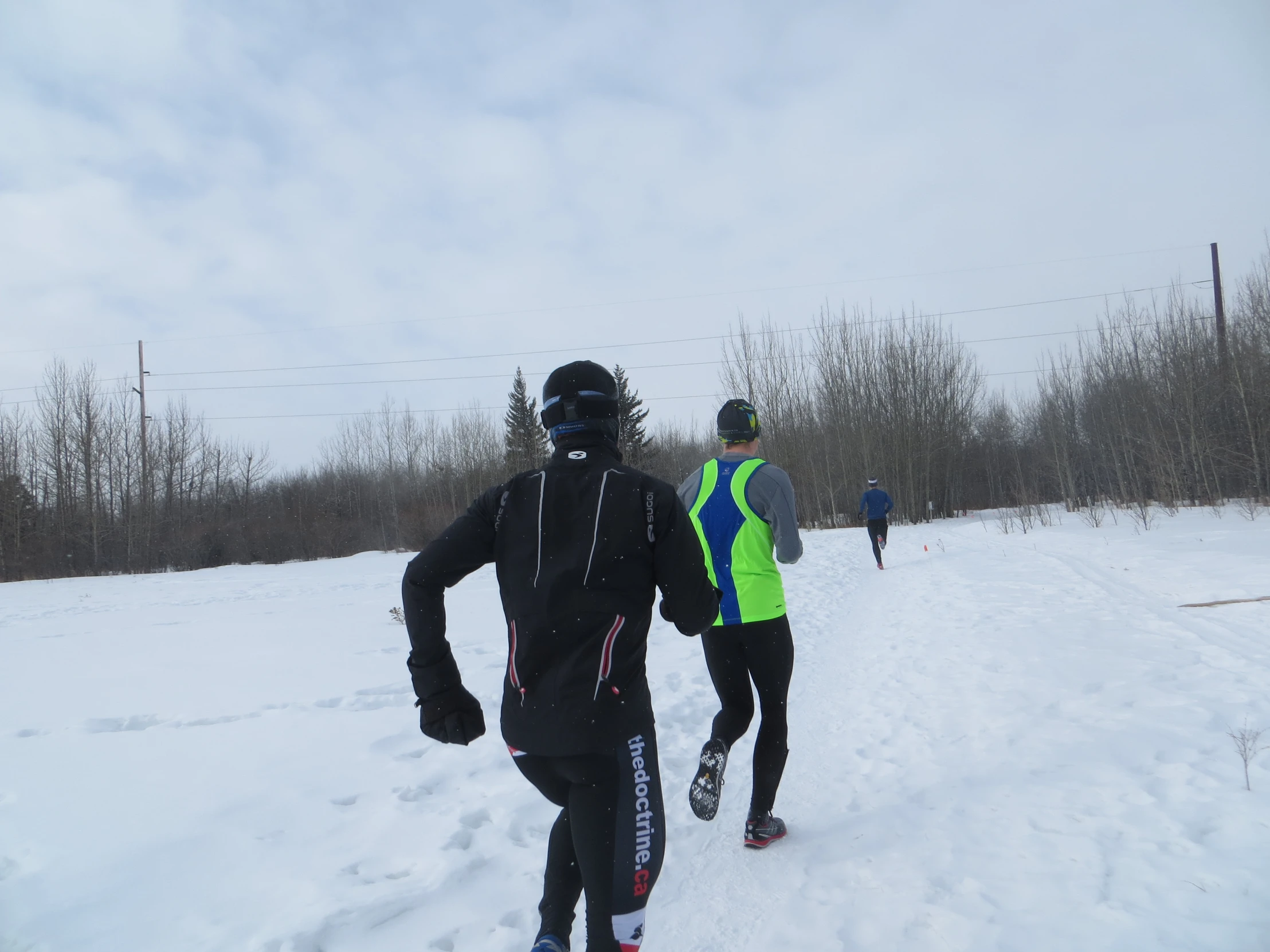 two people are skiing in the snow