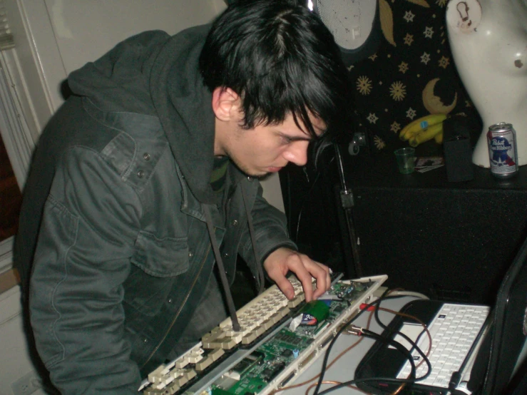 a man is using a machine to make electronic circuit boards