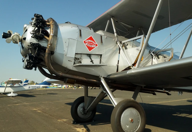 a small propeller plane sits parked at an airport