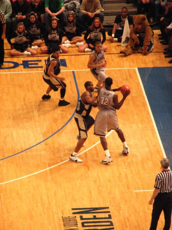 some men are playing basketball on a court