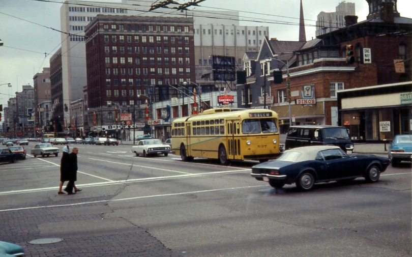 the city bus is going down the busy road