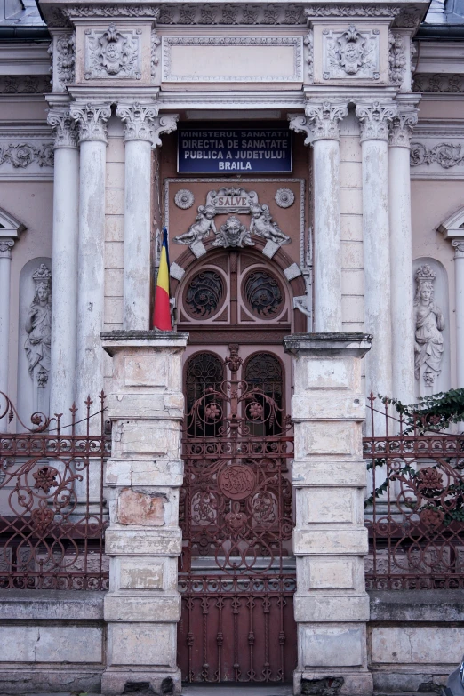 a large, ornate gate and entrance to a white and tan building