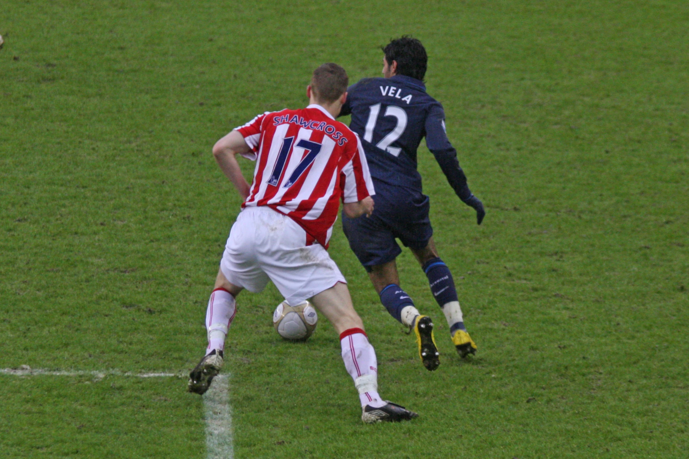 the soccer players are fighting for control of the ball