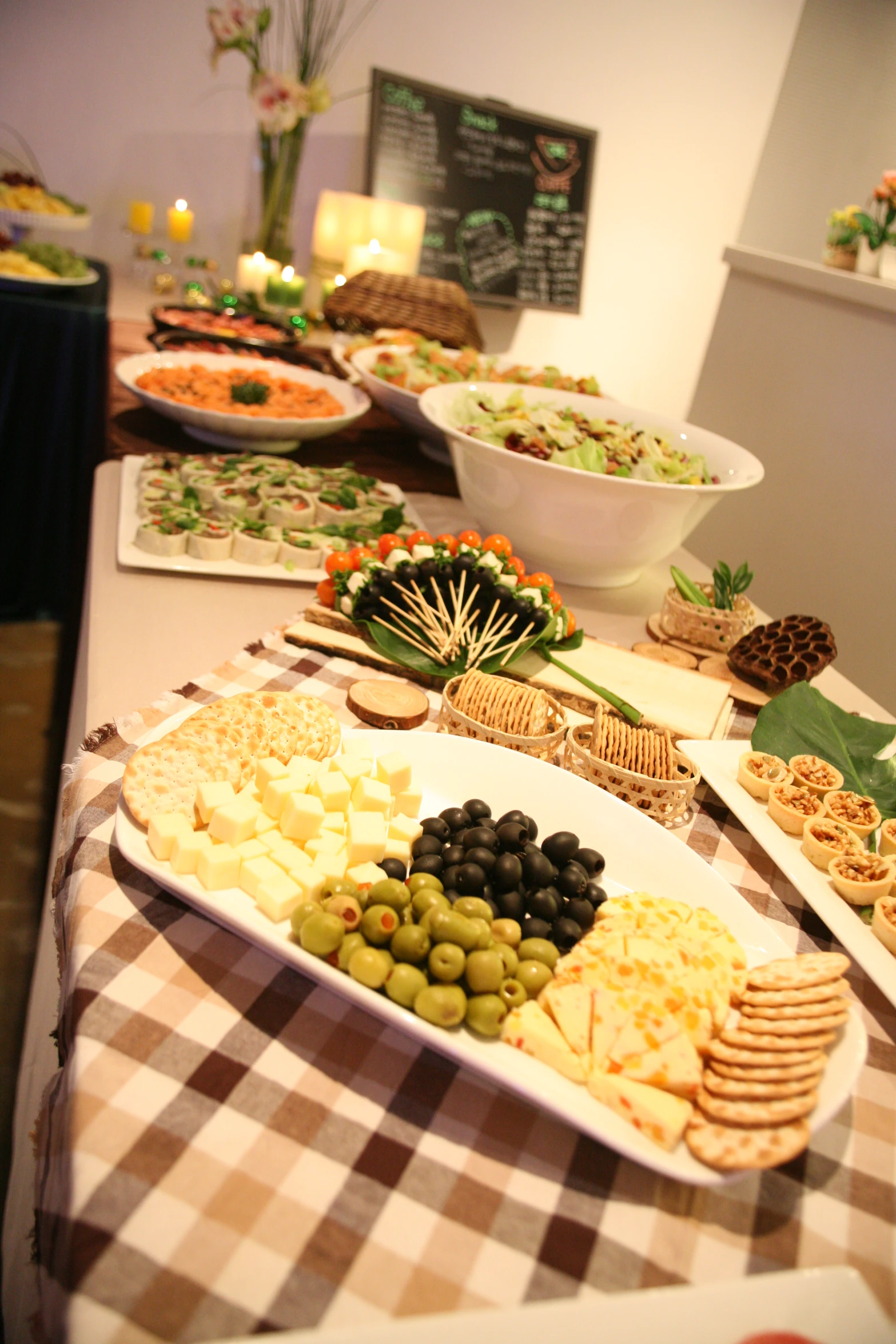 a buffet with olives, cheese and ers on the table