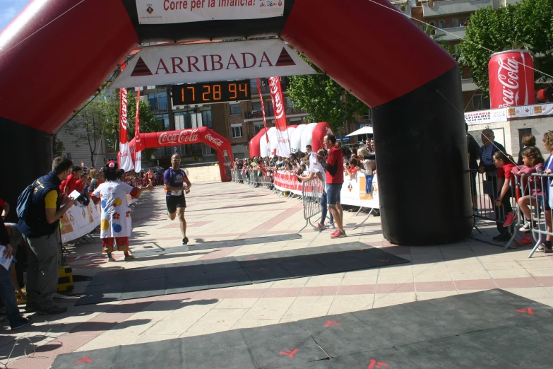 a run finish line with people crossing the finish line