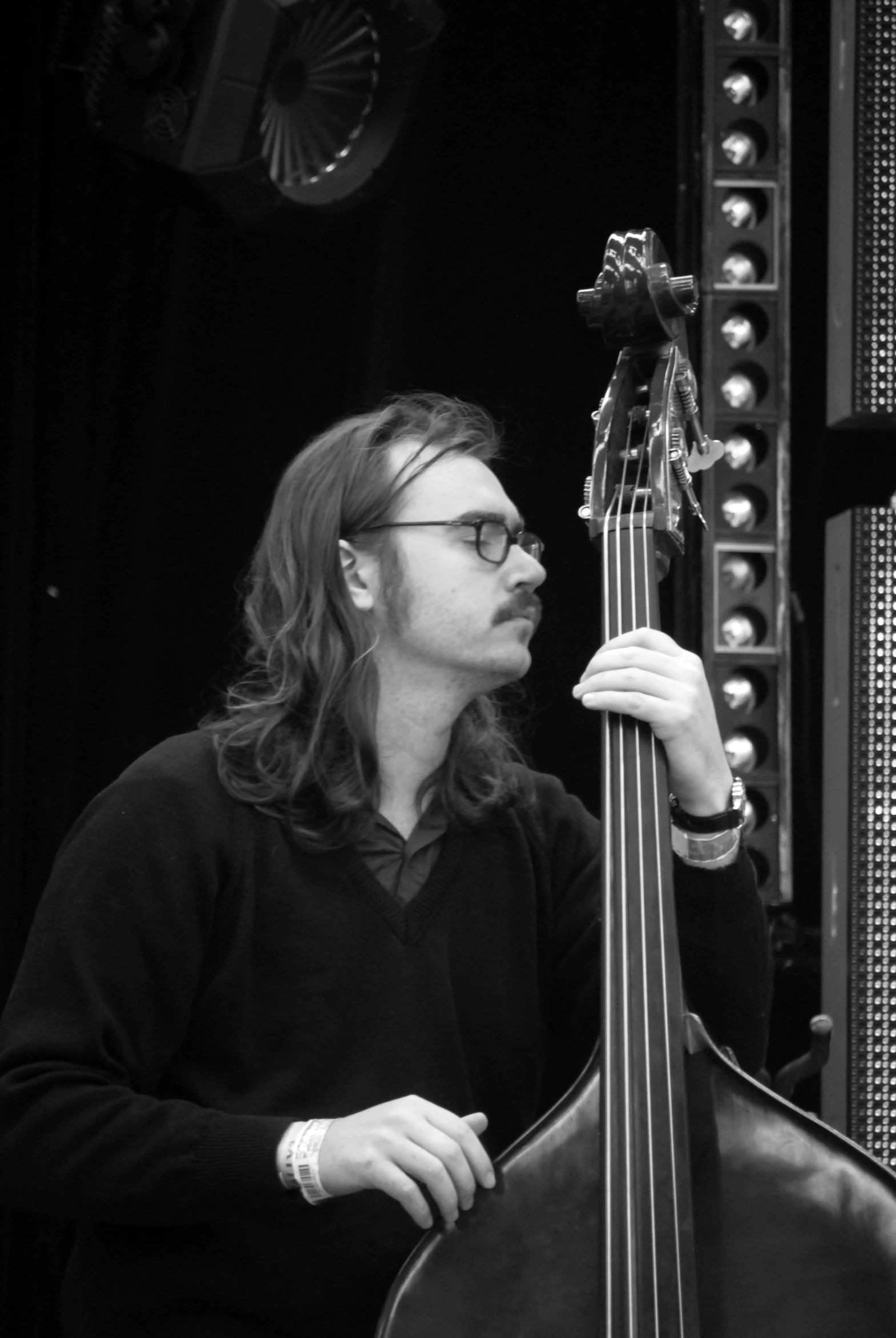 a black and white po of a musician with glasses and holding his instrument