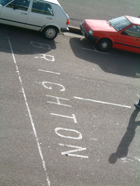 a parking space has white writing on the ground