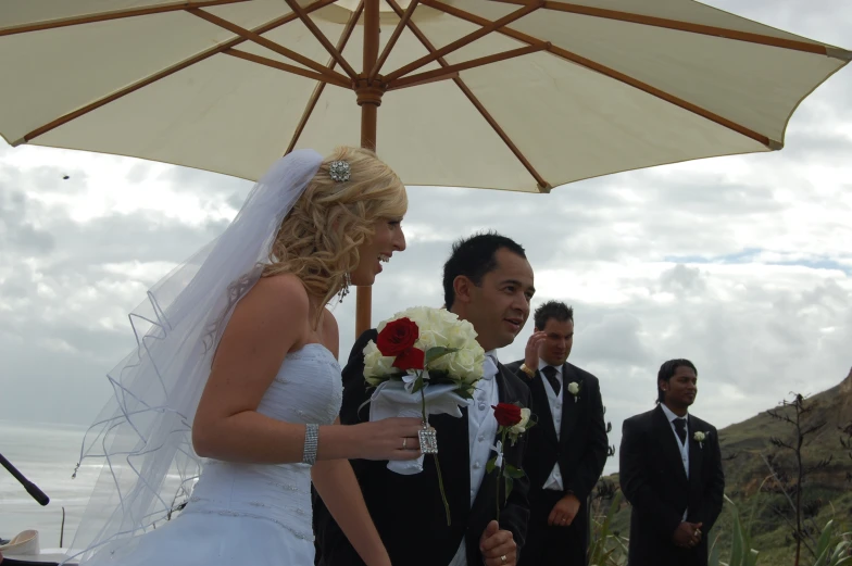 the newly married couple are surrounded by other guests