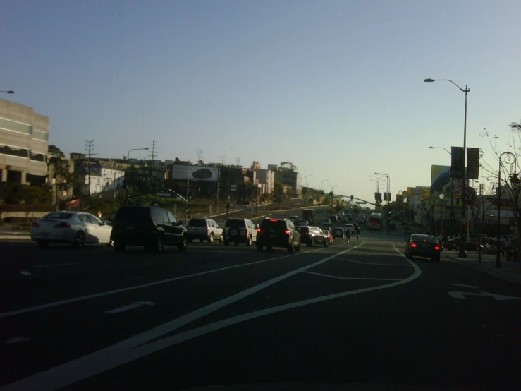 cars are stopped at an intersection with a sky background