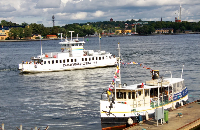 two large boats are docked at the dock