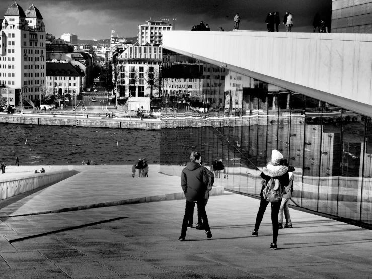 a couple of people are standing near water