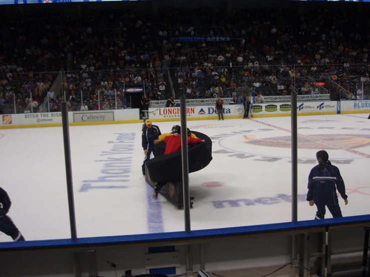 a hockey rink with an empty ice and two fans