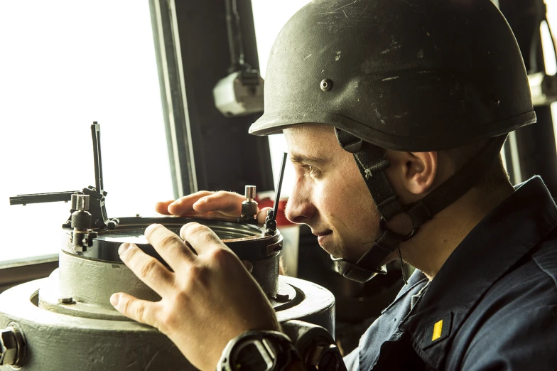 a military man wearing a helmet and protective gear smoking