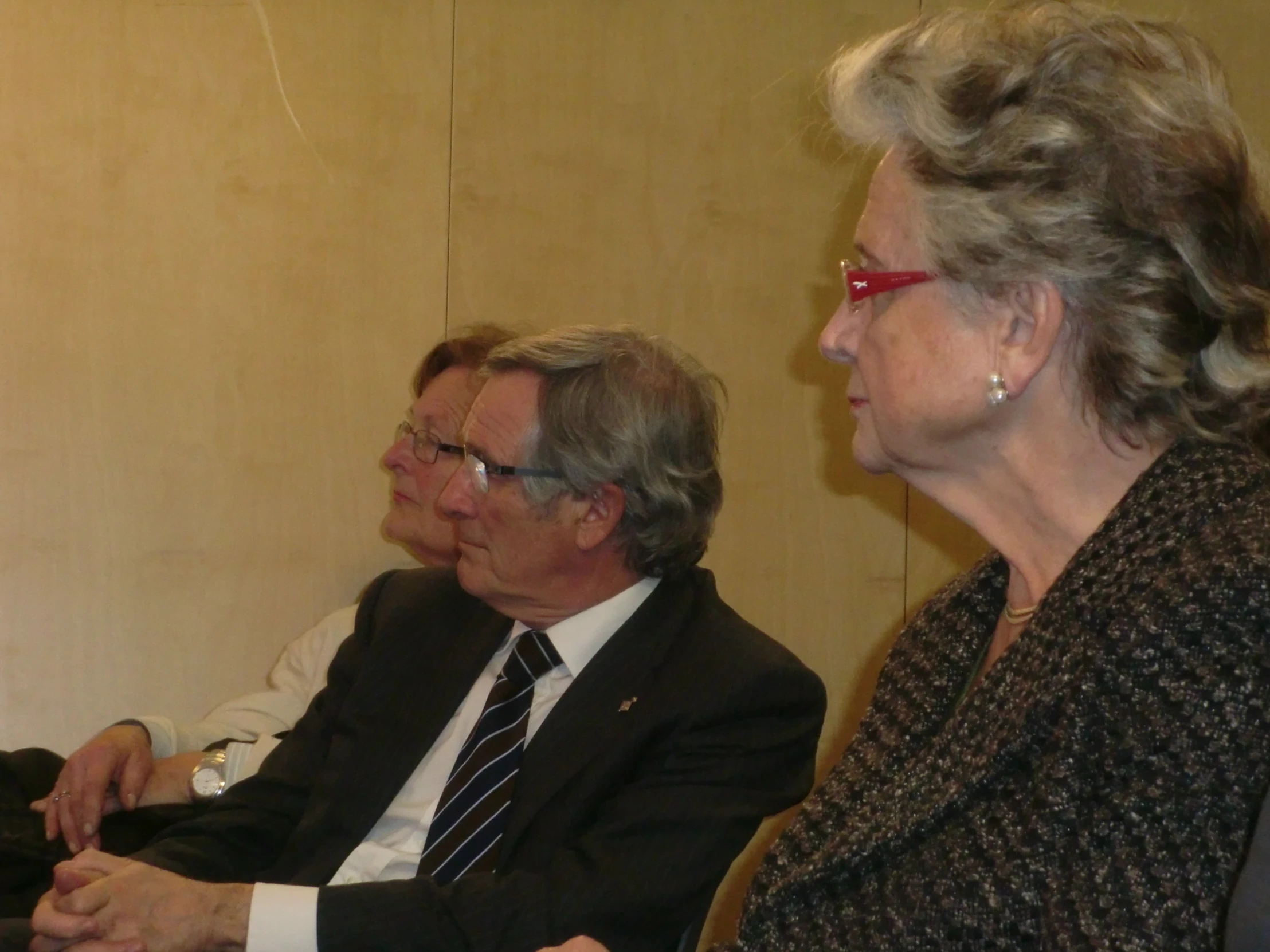 a man and woman sitting at a table with each other