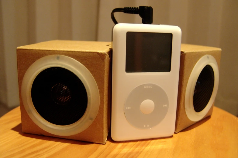 there is a small ipod next to a speaker