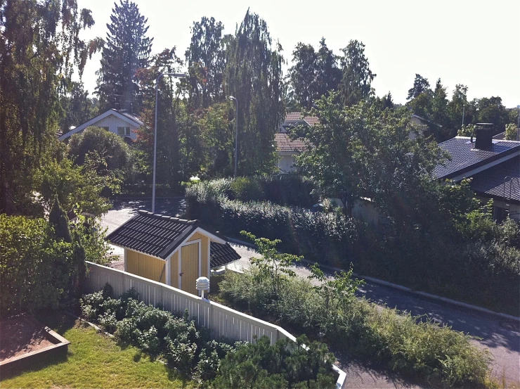 the houses are near the railroad tracks and trees