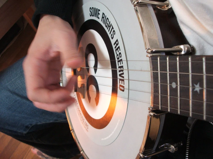 a person is playing a guitar with an advertit on the fret