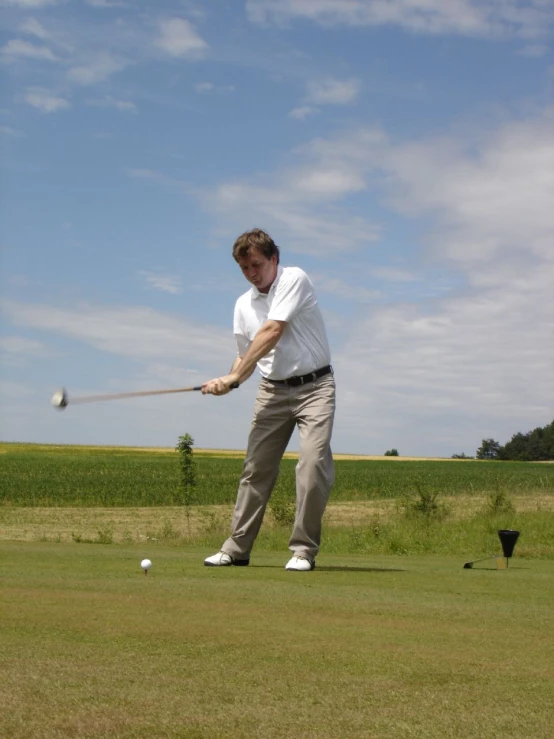 an athletic man about to hit a tee ball