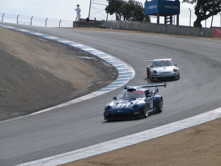 two racing cars driving on the race track