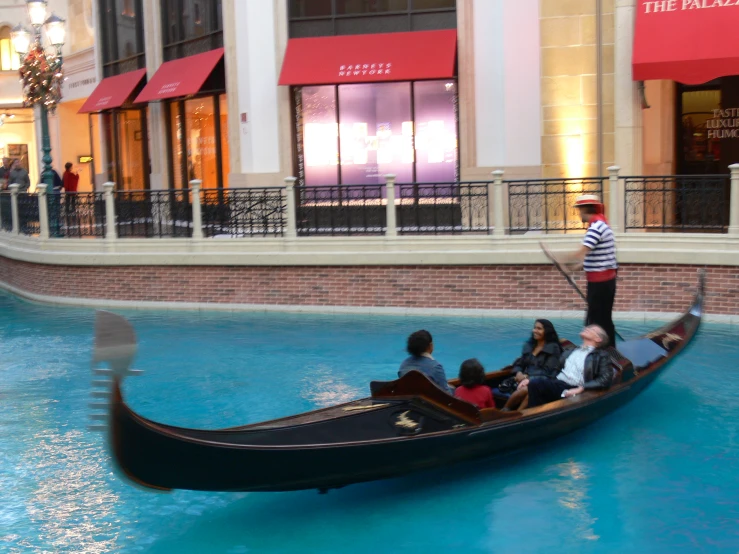 some people on gondola ride in a shopping mall