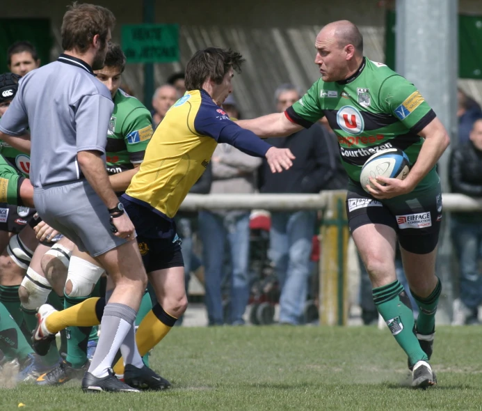 a rugby player runs to get past another player