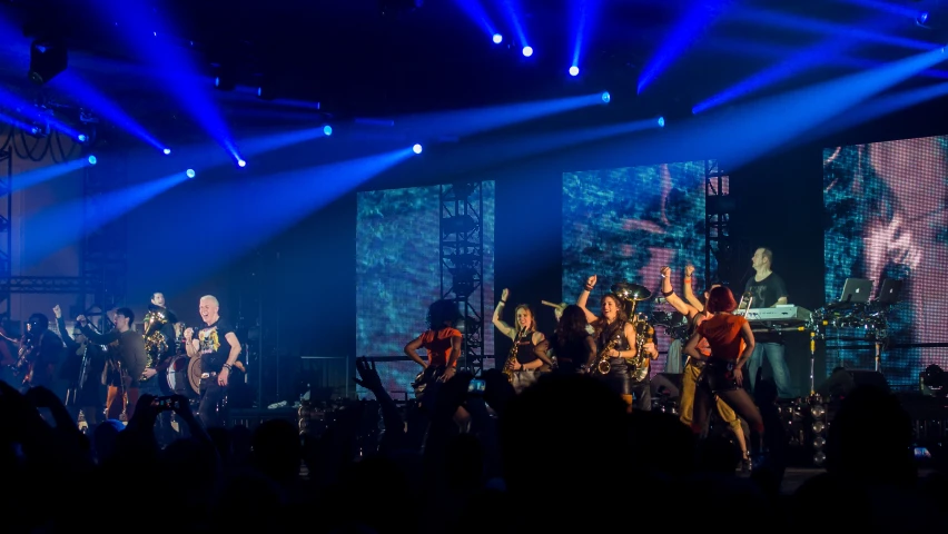 a group of people on stage in a music concert