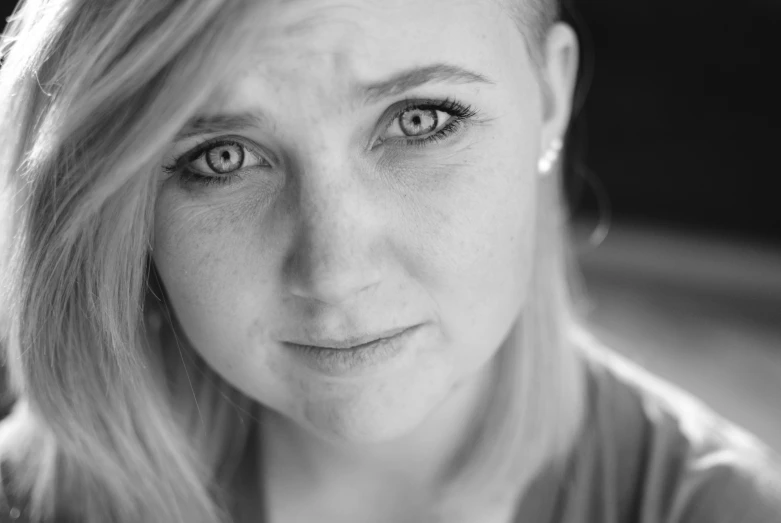 a woman with big, brown eyes is posing for a portrait