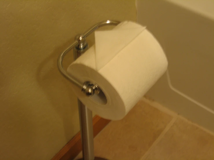a roll of white toilet paper sitting on top of a roll holder