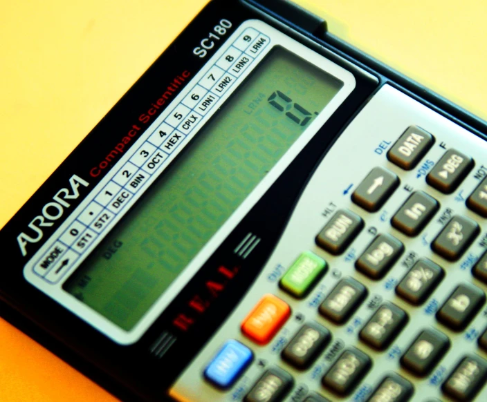 the top of a calculator is displayed on a table
