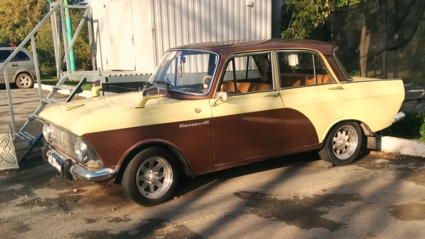 a yellow and brown car parked in front of a building