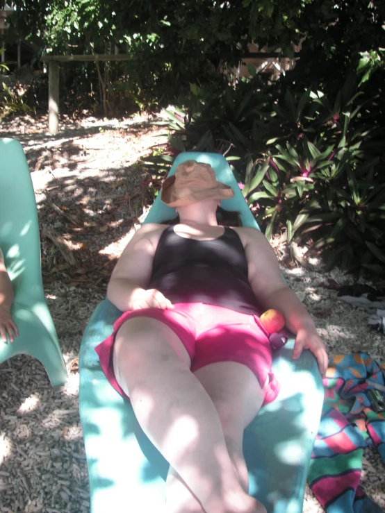 two women laying on lawn chairs in their bathing suits