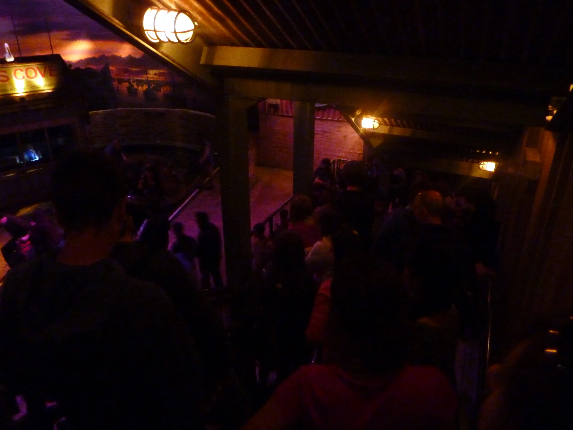 several people standing near a stair railing in a building