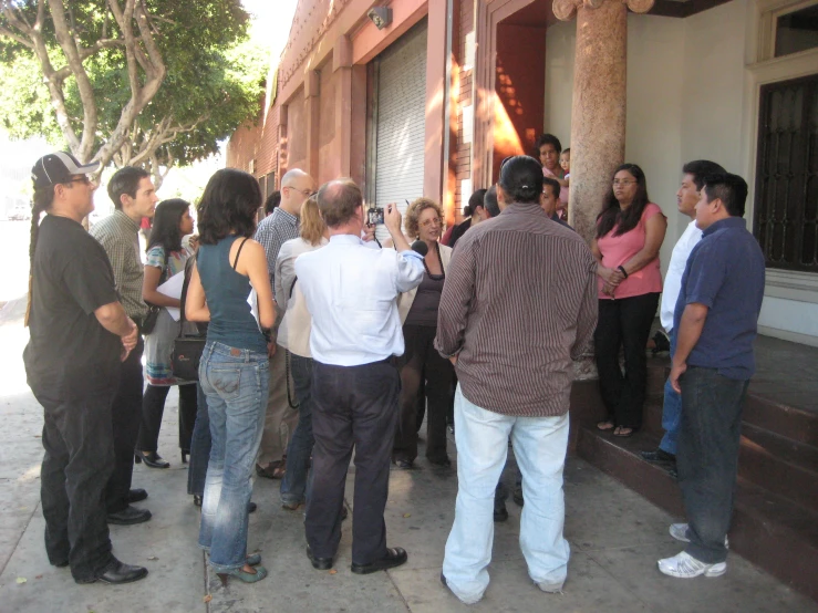 people standing in line near a building