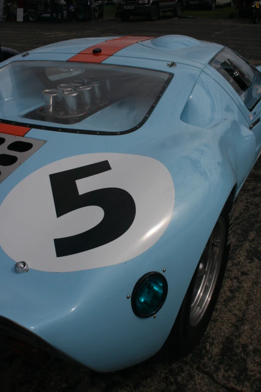 an old fashioned racing car with a number on the side